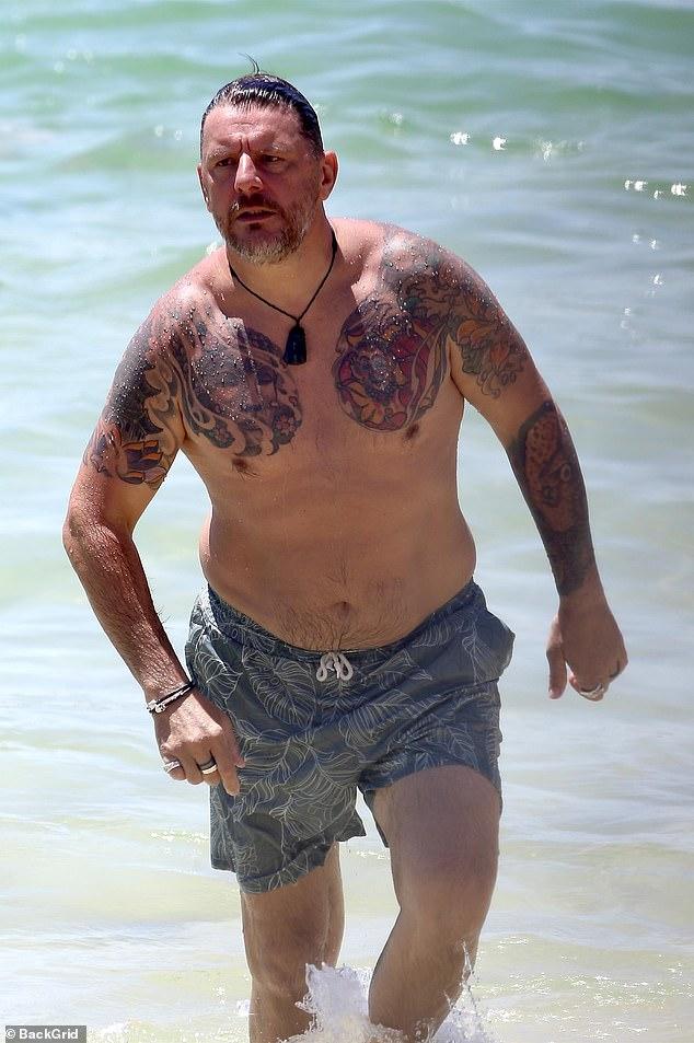 News Room : Shirtless My Kitchen Rules star Manu Feildel shows off his extensive tattoo collection after getting MORE ink as he hits the beach for a sweet outing with his mother