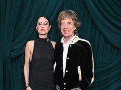News Room : Mick Jagger, 82, wraps an arm around braless fiancee Melanie Hamrick, 38, at starry pre-Oscars bash