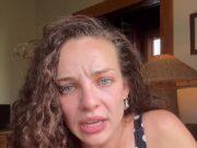 News Room : Abbie Chatfield commits major wardrobe faux pas in Instagram video: ‘I’m so embarrassed’ Upset woman with curly hair and blue eyes in a polka dot dress, indoors, emotional expression.