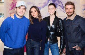 Young adults smiling at a news event in Sri Lanka, dressed casually with a colorful backdrop.