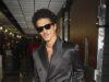 News Room : Bruno Mars breaks record for most tickets sold in a single day ahead of his hotly-anticipated new tour Stylish man in black satin double-breasted suit with sunglasses at airport.