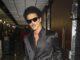 News Room : Bruno Mars breaks record for most tickets sold in a single day ahead of his hotly-anticipated new tour Stylish man in black satin double-breasted suit with sunglasses at airport.