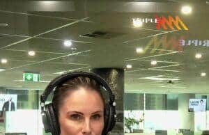 News Room : Candice Warner reveals next big ‘cutthroat’ career move: ‘I’m very goal driven’ Woman broadcasting live at a radio station studio in a modern office environment.