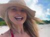 News Room : Christie Brinkley, 71, shows off cleavage in red bikini top during tropical getaway Bright smiling woman in sun hat at beach, enjoying a sunny day in Sri Lanka.