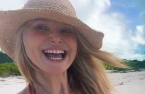 News Room : Christie Brinkley, 71, shows off cleavage in red bikini top during tropical getaway Bright smiling woman in sun hat at beach, enjoying a sunny day in Sri Lanka.