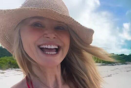 Bright smiling woman in sun hat at beach, enjoying a sunny day in Sri Lanka.