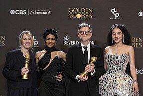 Four award winners posing with their trophies at a prestigious event.