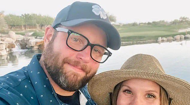 Smiling couple outdoors by water, enjoying the moment on a sunny day.