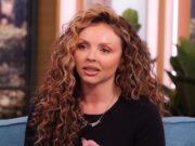 News Room : Jesy Nelson shares new pictures of her twin baby daughters on a walk after opening up about their heartbreaking muscle weakening condition Curly-haired woman speaking passionately on a talk show set.