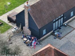 Overflowing trash bags outside a house, indicating improper waste management.