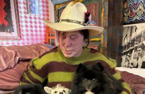 News Room : Mickey Rourke’s dog needs $10K heart surgery… as he tries to return $100K donation from fans Pet-loving woman with three dogs in cozy room, showcasing a bond with her pets.