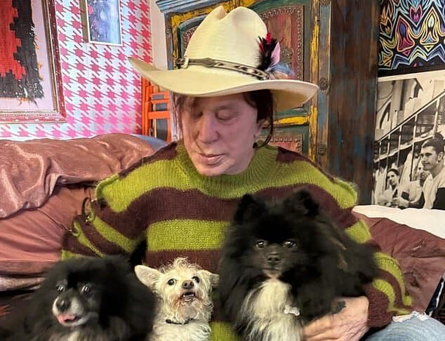 Pet-loving woman with three dogs in cozy room, showcasing a bond with her pets.