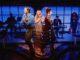 News Room : West End musical Titanique mocks Beckham family feud during first anniversary gala – after Brooklyn’s bombshell statement Performers on stage during a theatrical show in a vibrant, modern setting with live musicians in the background.