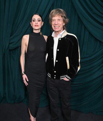 News Room : Mick Jagger, 82, wraps an arm around braless fiancee Melanie Hamrick, 38, at starry pre-Oscars bash News Room Mick Jagger 82 wraps an arm around